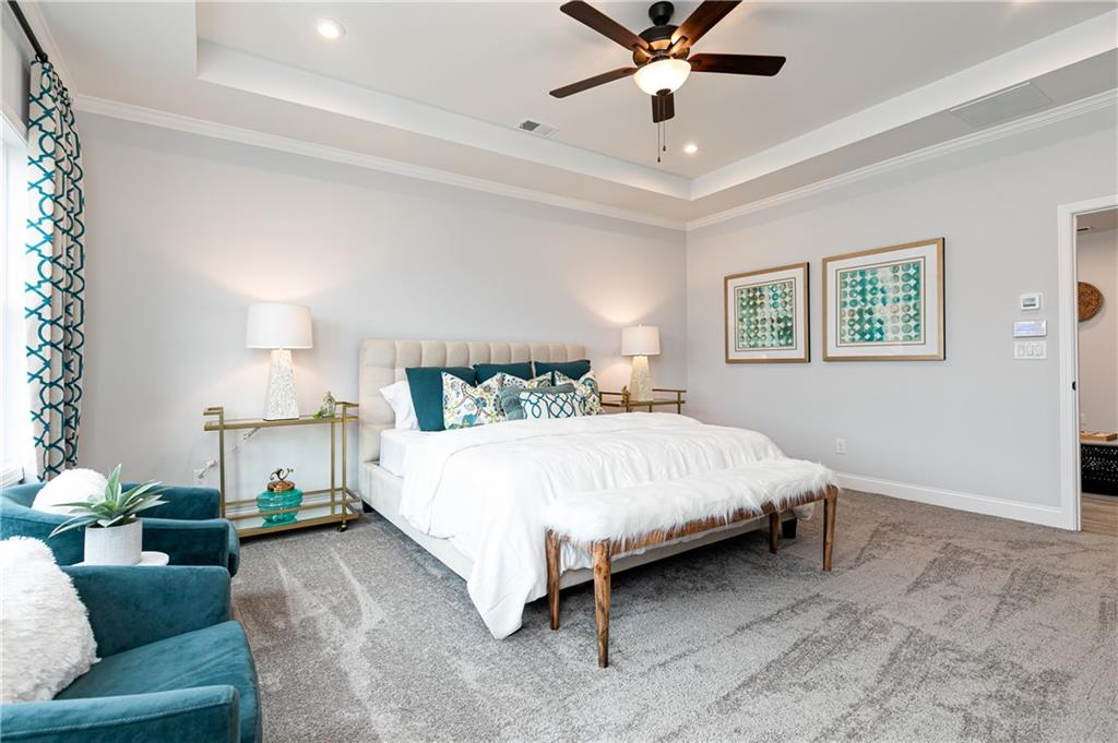 862 Leraes Way Loganville, GA 30052 - Photo 25 of 56 a spacious bedroom with a bed couch and window