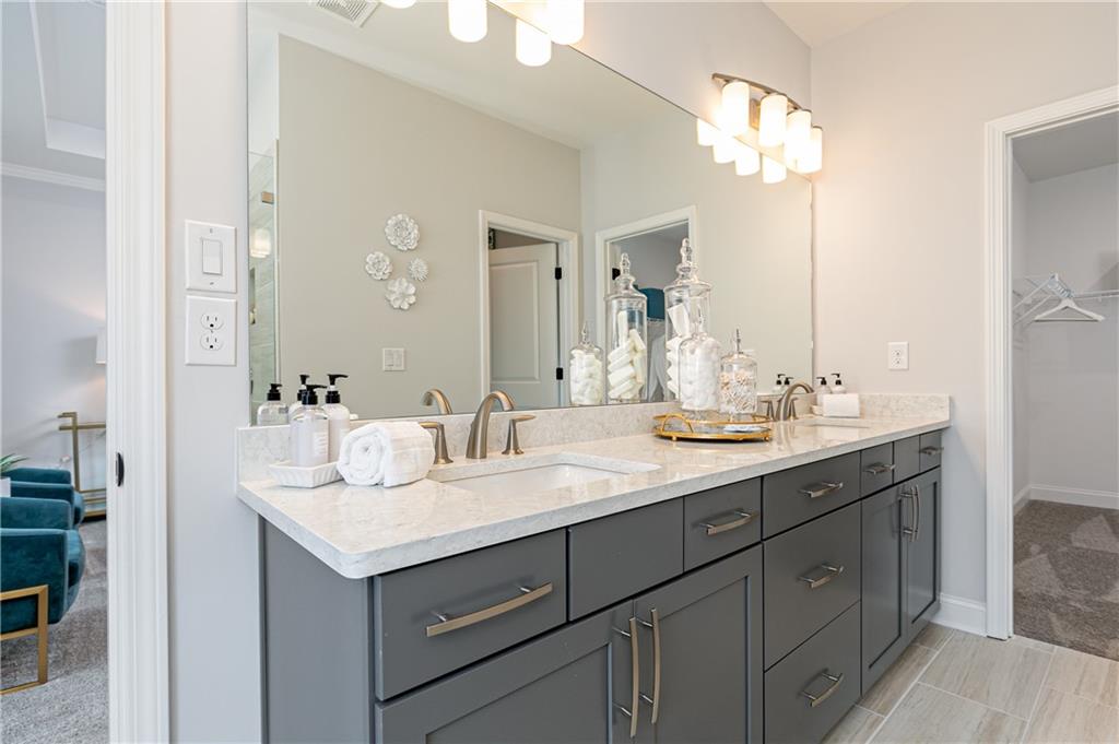 862 Leraes Way Loganville, GA 30052 - Photo 27 of 56 a bathroom with a sink double vanity and a mirror