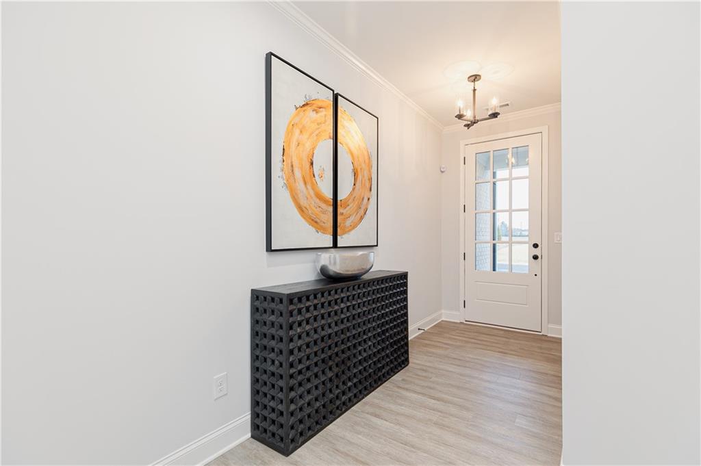 862 Leraes Way Loganville, GA 30052 - Photo 3 of 56 a hallway with wooden floor windows and stairs