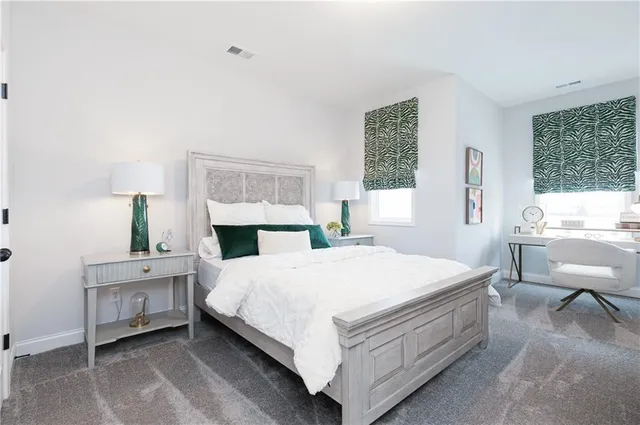 a bathroom with a granite countertop sink a toilet and a mirror