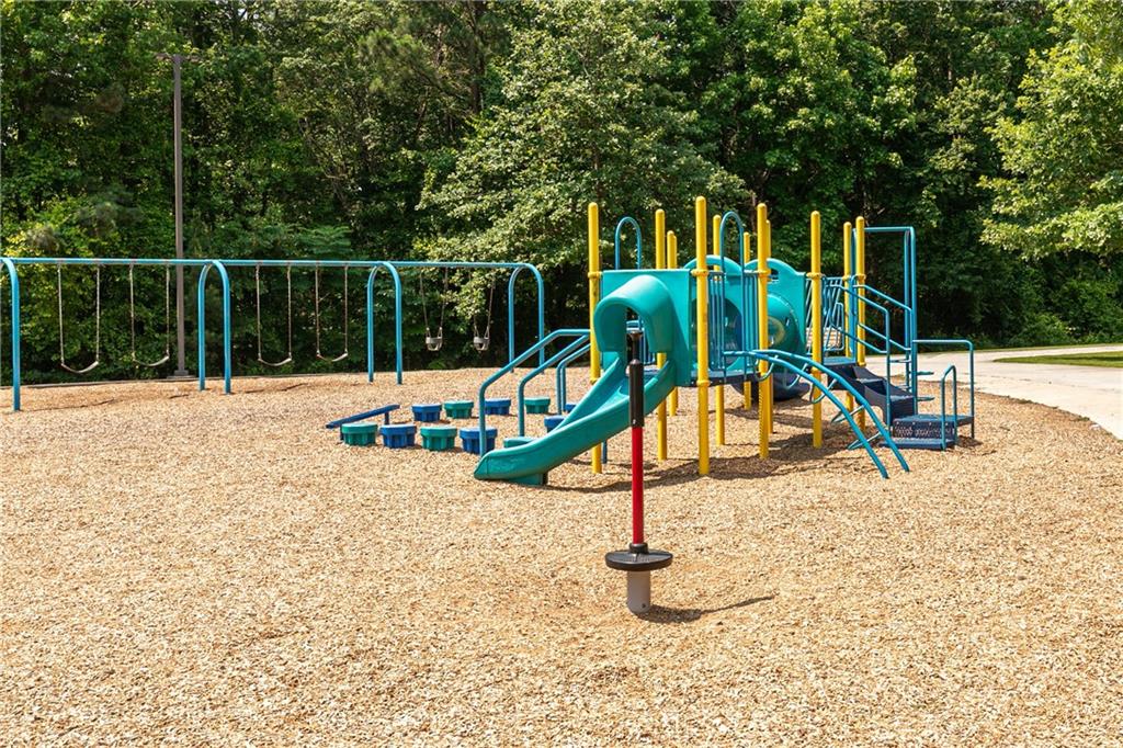 862 Leraes Way Loganville, GA 30052 - Photo 52 of 56 a park view with a slide and swing