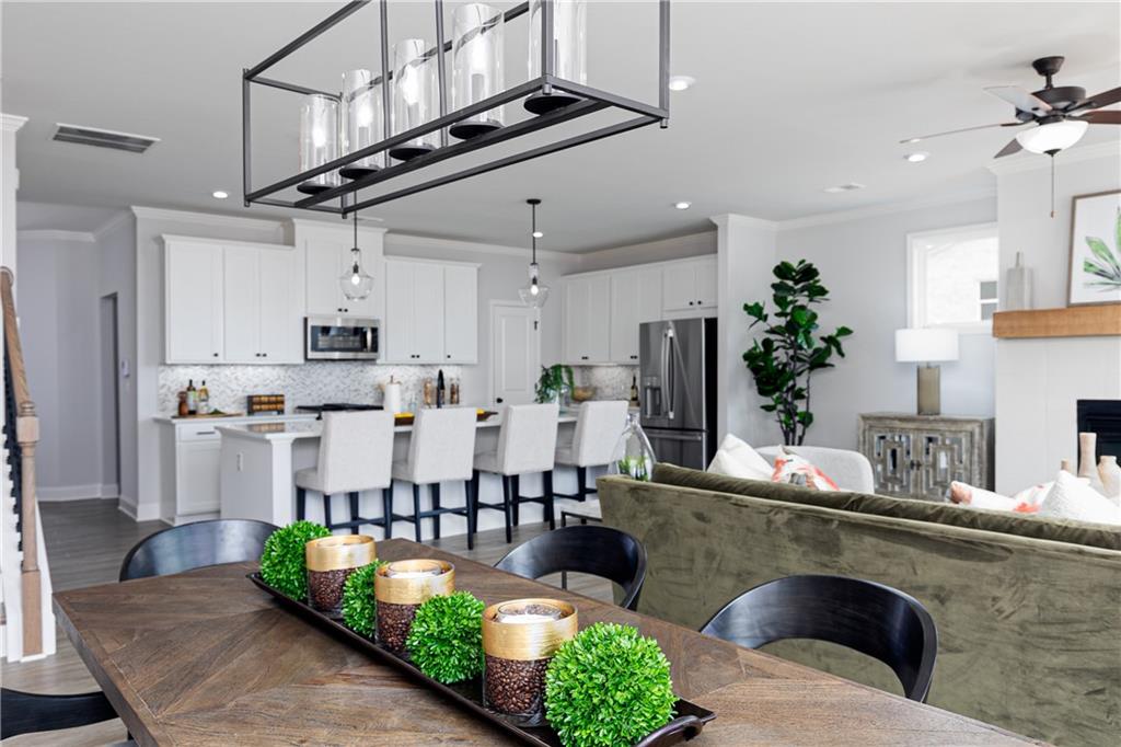 862 Leraes Way Loganville, GA 30052 - Photo 9 of 56 a living room with stainless steel appliances kitchen island granite countertop furniture and a view of kitchen