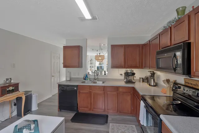 a kitchen with a sink a stove and cabinets