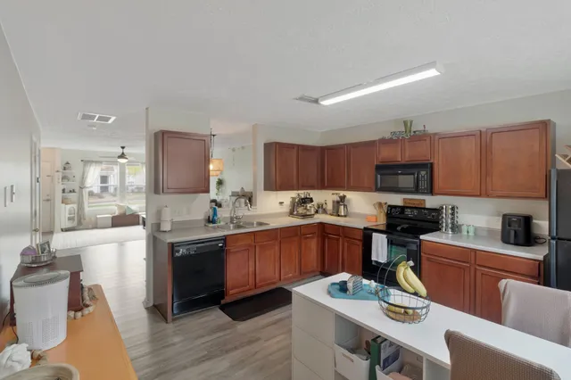 a kitchen with stainless steel appliances kitchen island granite countertop a sink and cabinets