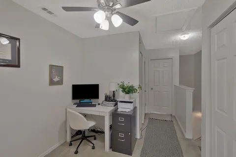 a view of a workspace with furniture and a flat screen tv