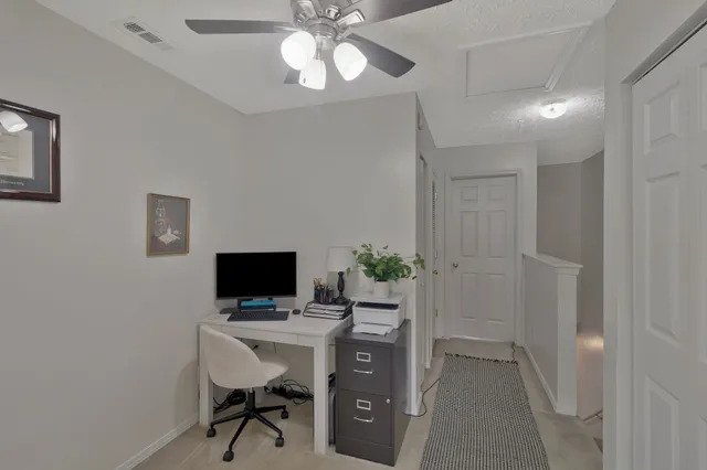 a view of a workspace with furniture and a flat screen tv