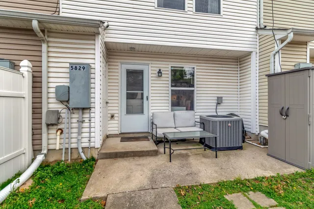 a backyard of a house with outdoor seating