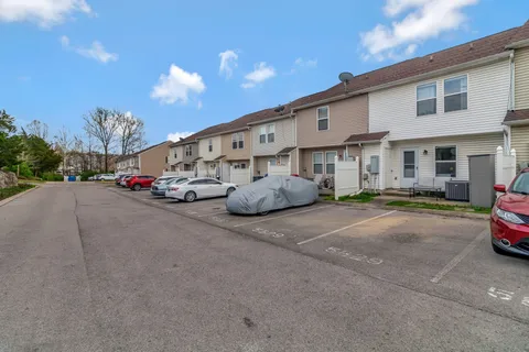 a car parked in front of a white house