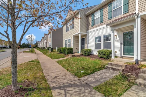a view of a brick building next to a yard