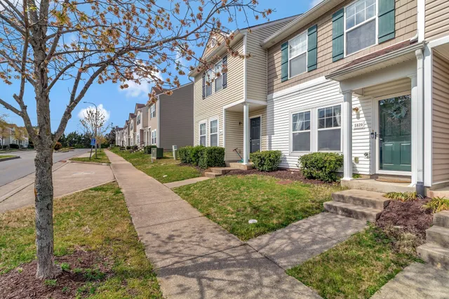 a view of a brick building next to a yard