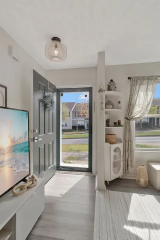 a view of a livingroom with furniture wooden floor and window