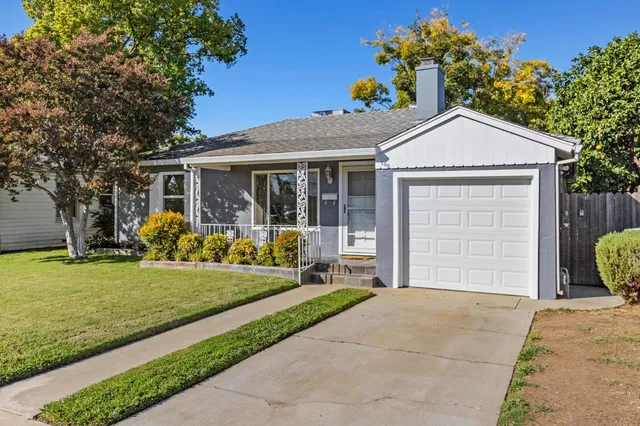 a front view of a house with garden and porch