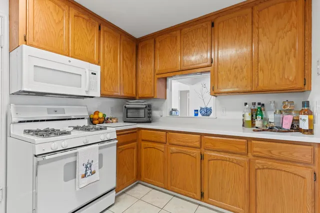 a kitchen with cabinets appliances a sink and a window