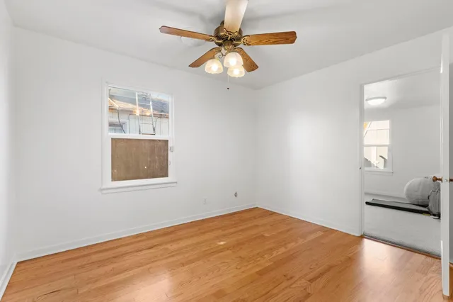 a view of empty room with wooden floor