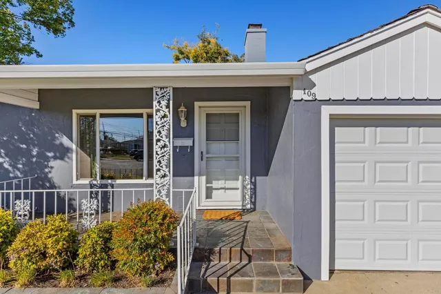 front view of a house with a large window