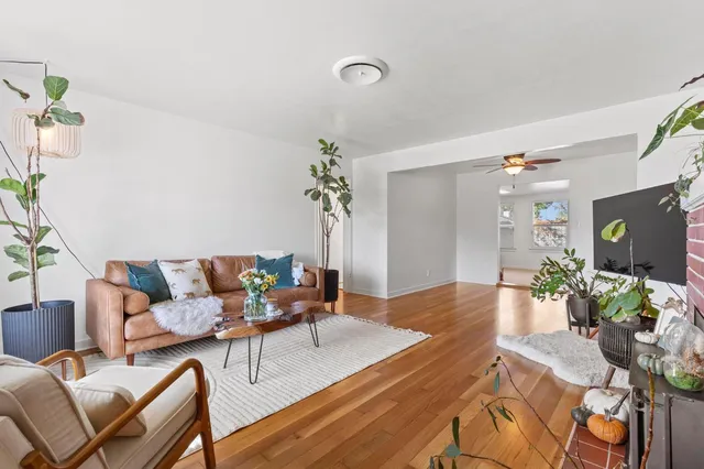 a living room with furniture and wooden floor