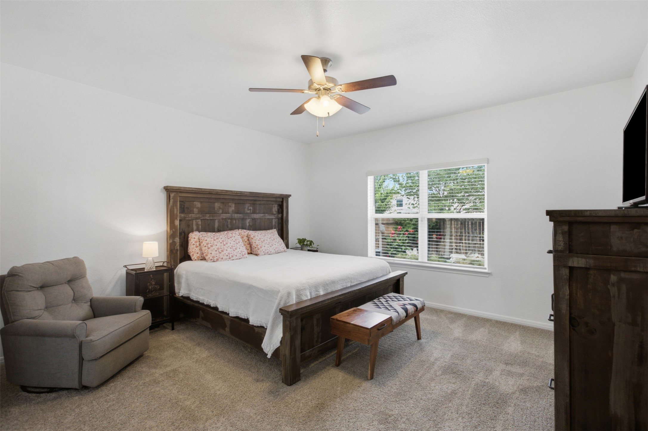 2413 Bridges Ranch Road Georgetown, TX 78628 - Photo 15 of 31 A tranquil primary bedroom offering comfort with a classic ceiling fan and plush carpeted flooring.