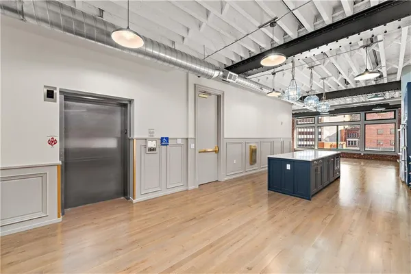 a kitchen with stainless steel appliances granite countertop a sink a stove and a wooden floors