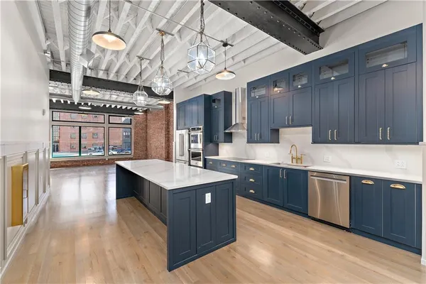 a large white kitchen with a large window