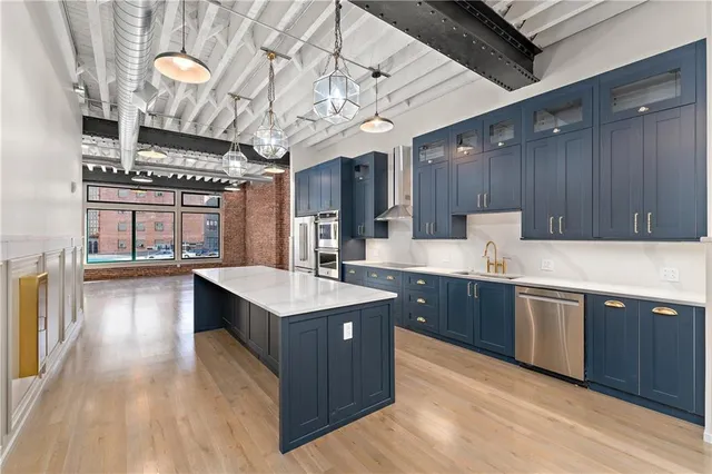 a large white kitchen with a large window