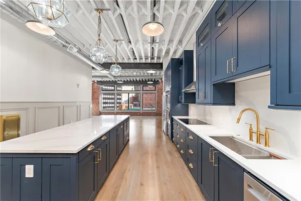 a kitchen with granite countertop wooden cabinets and stainless steel appliances