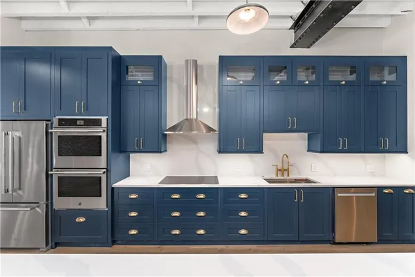 a kitchen with stainless steel appliances granite countertop a refrigerator a sink dishwasher a stove and a refrigerator