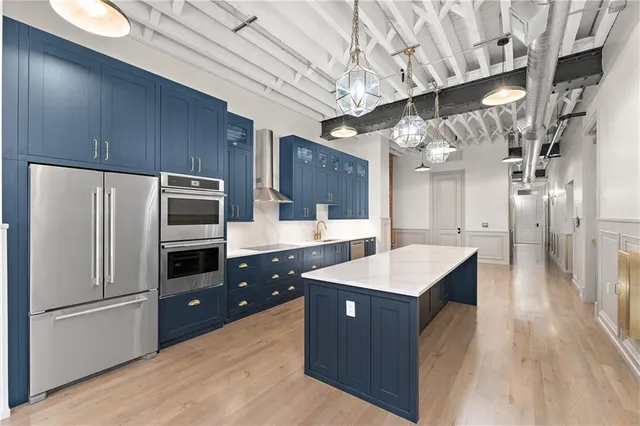a kitchen with a sink refrigerator and cabinets