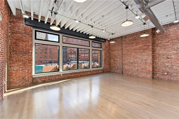 a view of empty room with wooden floor