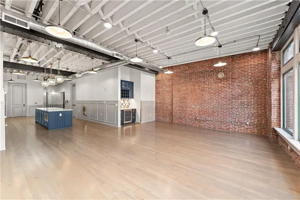a view of a livingroom with furniture and a kitchen