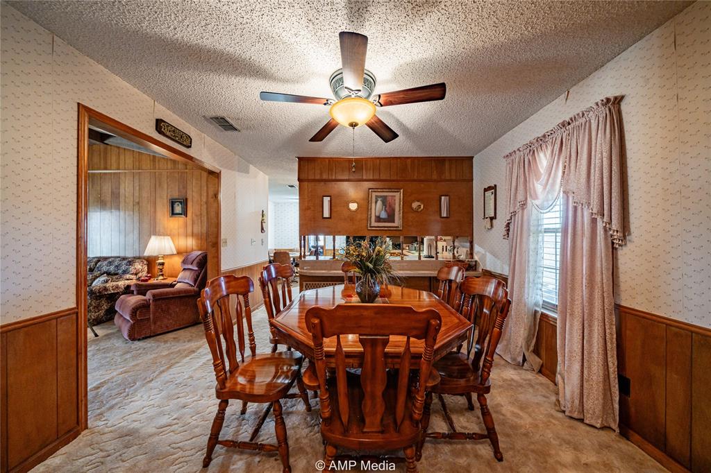 1992 Sand Flat Road Jacksboro, TX 76458 - Photo 29 of 36 Dining area with ceiling fan, light colored carpet, and a textured ceiling
