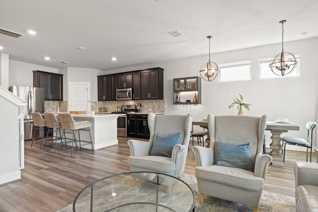 7403 Travertine Spring Drive, Unit 117 Austin, TX 78744 - Photo 12 of 37 An open-concept design with sleek hardwood-style flooring, a well-appointed kitchen, and comfortable living spaces.