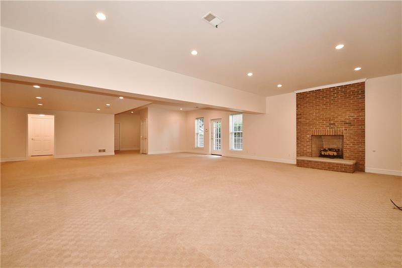115 Haverford Circle Pittsburgh, PA 15228 - Photo 20 of 25 Heading downstairs to the lower level basement, one finds a completely finished second family room. Gas fireplace, a separate kitchenette, and full bath. The lower level is walk-out.... note door leading to a small patio outside.