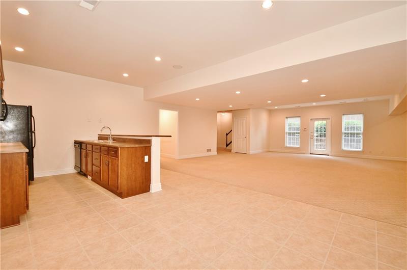 115 Haverford Circle Pittsburgh, PA 15228 - Photo 21 of 25 View of the lower level basement family room, with kitchenette off to the side.