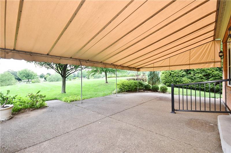 115 Haverford Circle Pittsburgh, PA 15228 - Photo 24 of 25 View of the awning-covered private back patio, and back yard. This area is accessed via the living room.