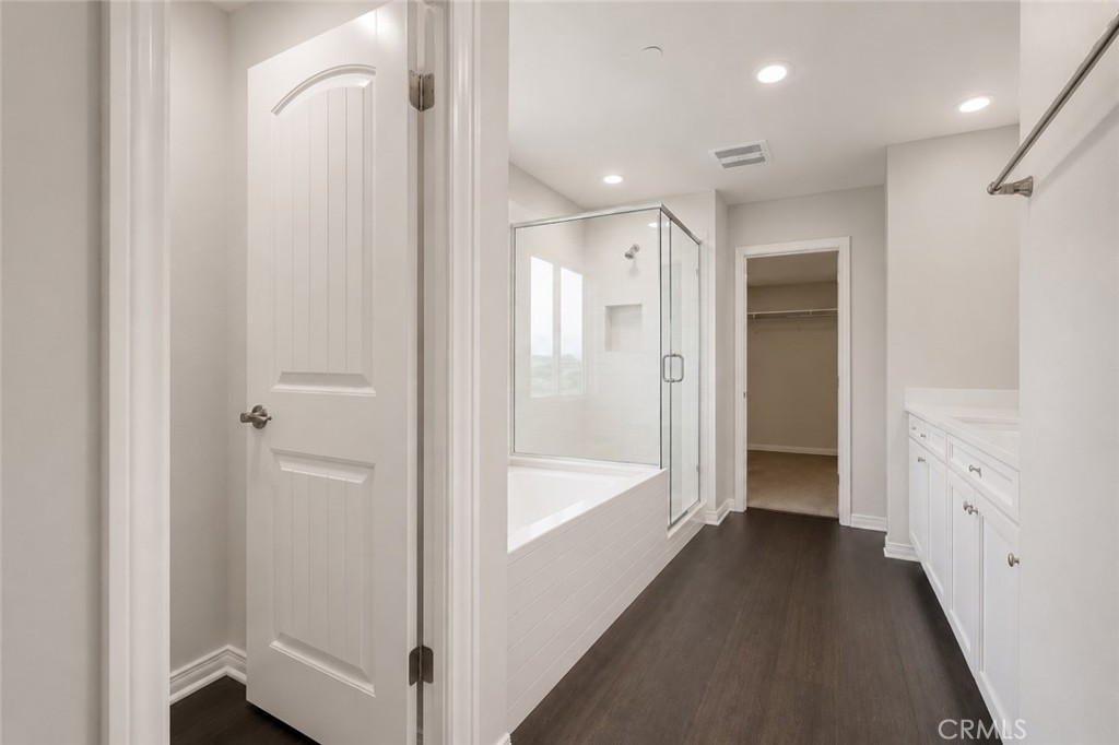 11056 Guffey Ranch Way Corona, CA 92883 - Photo 28 of 61 a bathroom with a glass shower door and a sink