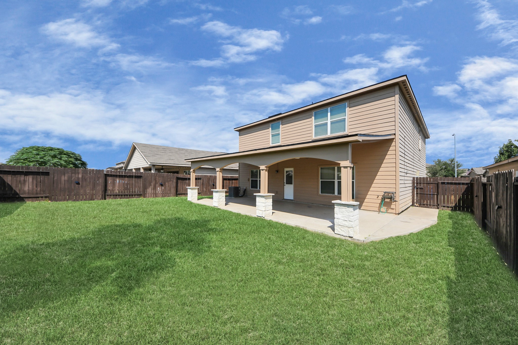 6931 Primrose Road Baytown, TX 77521 - Photo 47 of 50 Expansive backyard with a large covered patio, offering plenty of room for outdoor activities.