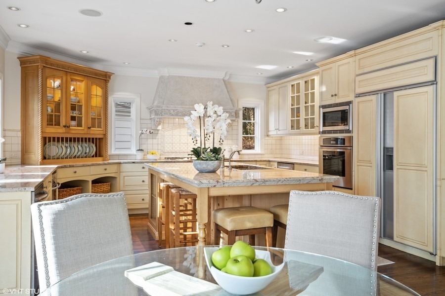 106 Woodley Road Winnetka, IL 60093 - Photo 23 of 44 a kitchen with a stove a sink and a refrigerator