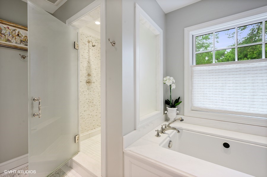 106 Woodley Road Winnetka, IL 60093 - Photo 30 of 44 a bathroom with a bathtub and a shower