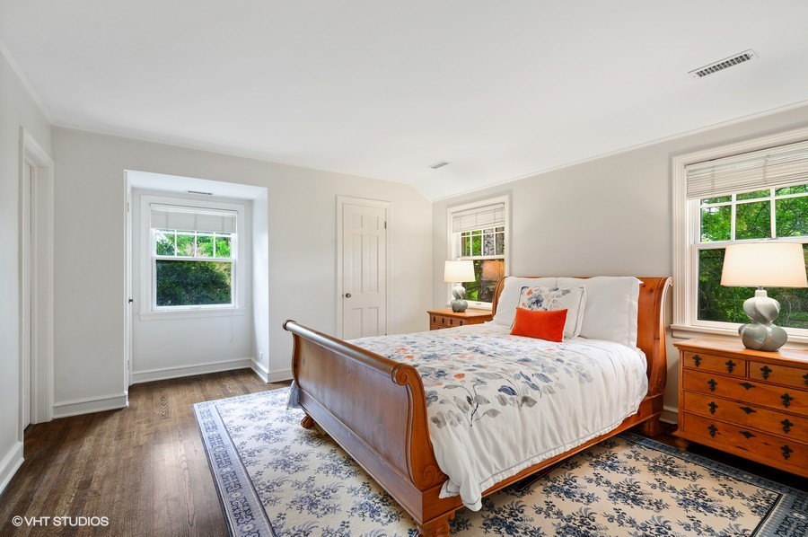 106 Woodley Road Winnetka, IL 60093 - Photo 35 of 44 a bedroom with a bed and wooden floor