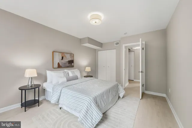 a bedroom with a bed and a lamp