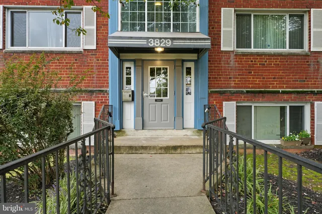 a view of a brick house with large windows and a table