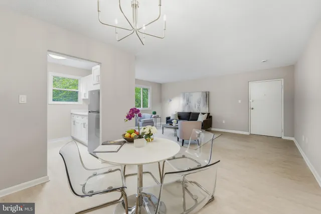 a view of a dining room with furniture and a potted plant