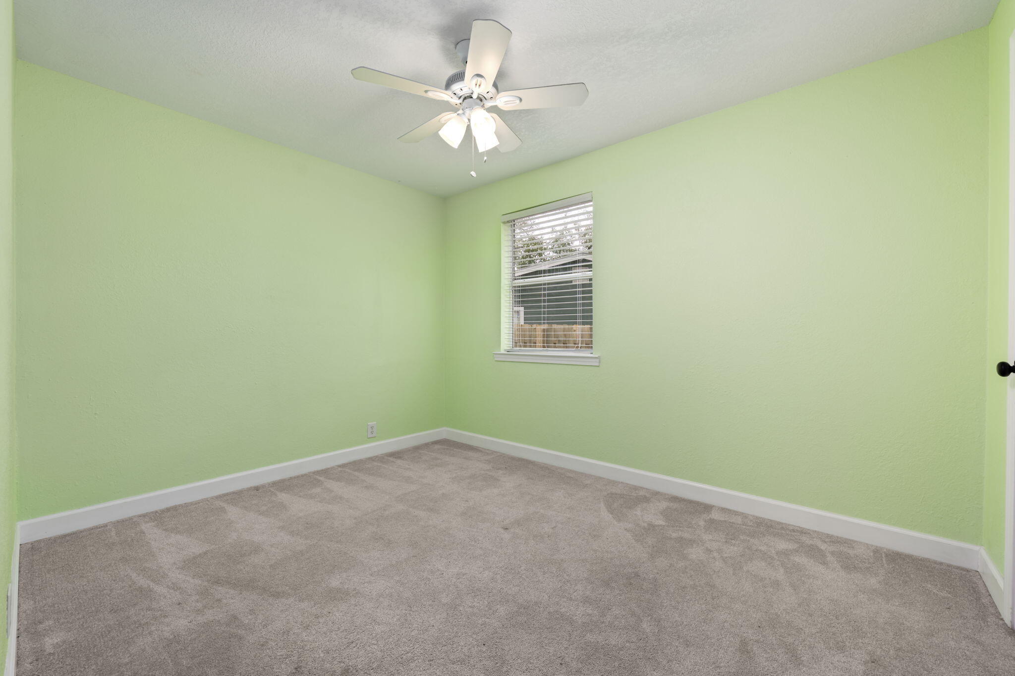255 Edge Avenue Valparaiso, FL 32580 - Photo 38 of 73 an empty room with a window and a fan