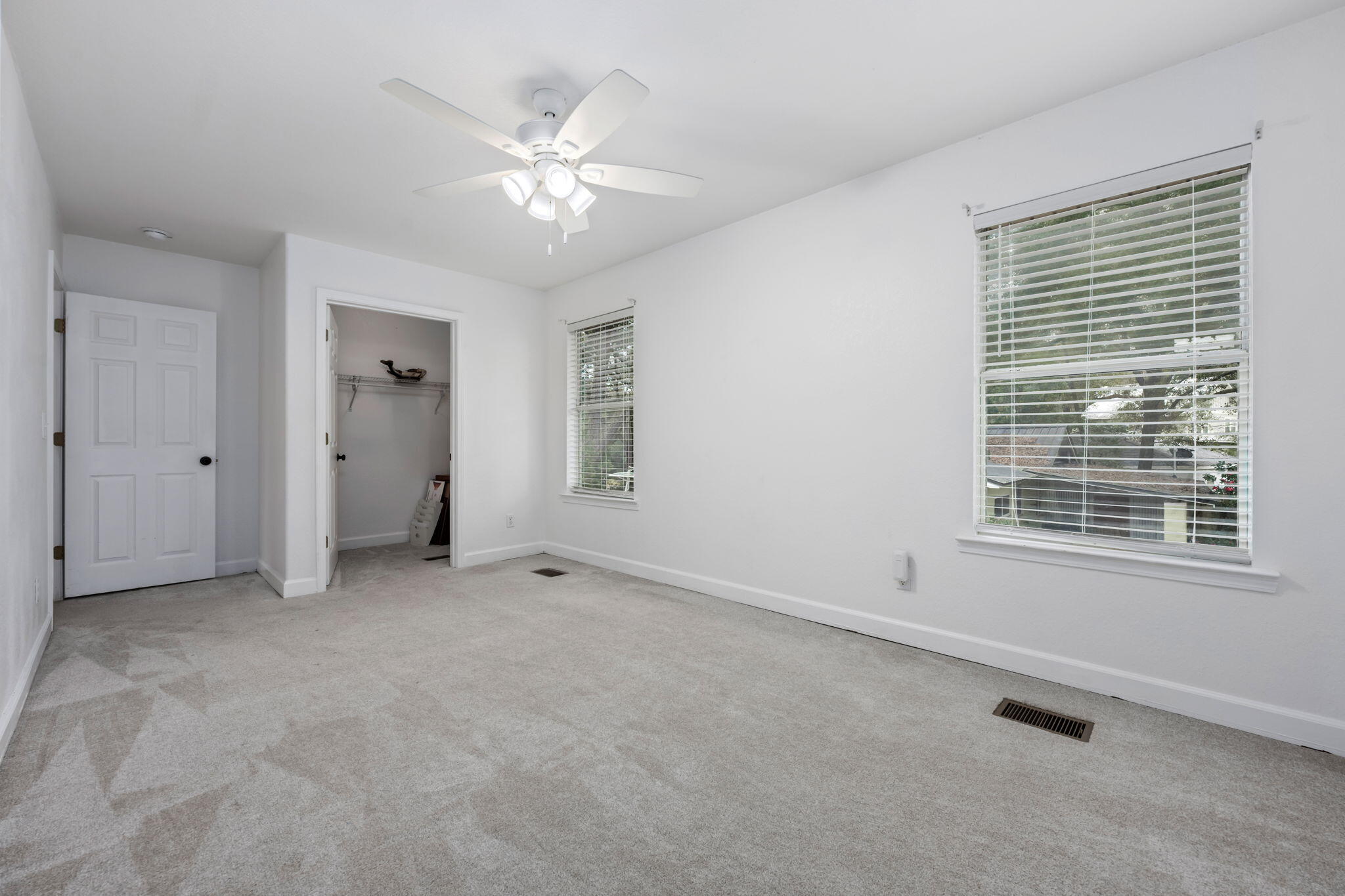 255 Edge Avenue Valparaiso, FL 32580 - Photo 49 of 73 an empty room with chandelier fan and windows