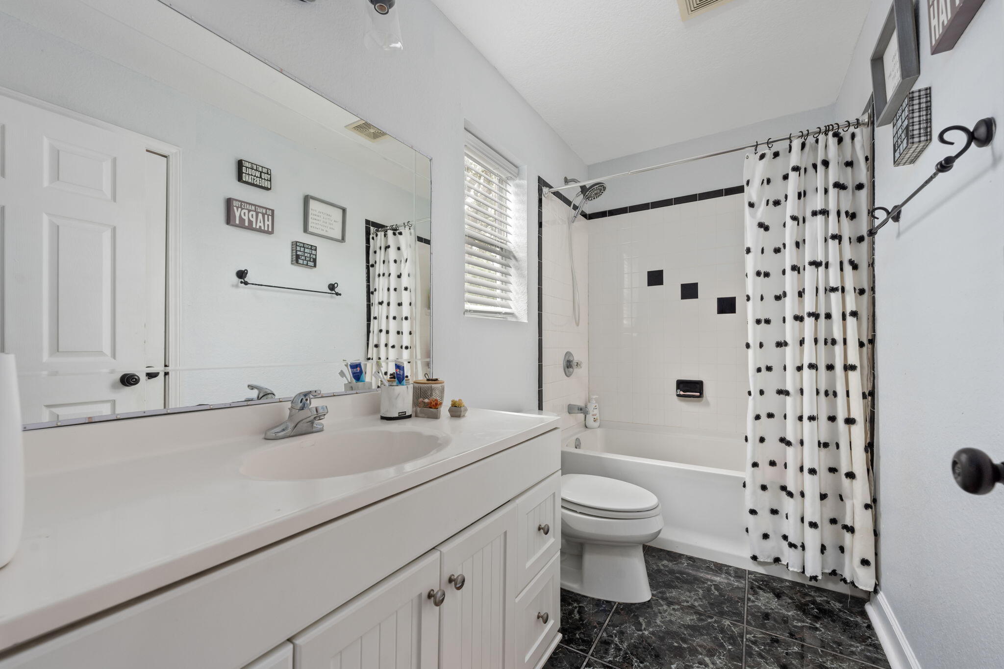 255 Edge Avenue Valparaiso, FL 32580 - Photo 50 of 73 a bathroom with a sink a toilet and shower curtain