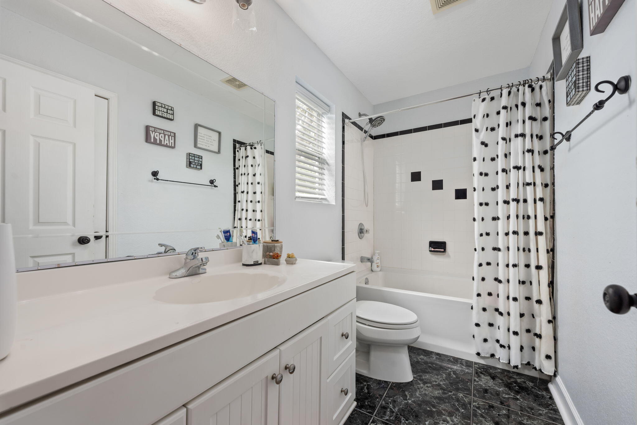 255 Edge Avenue Valparaiso, FL 32580 - Photo 51 of 73 a bathroom with a sink a toilet and shower curtain