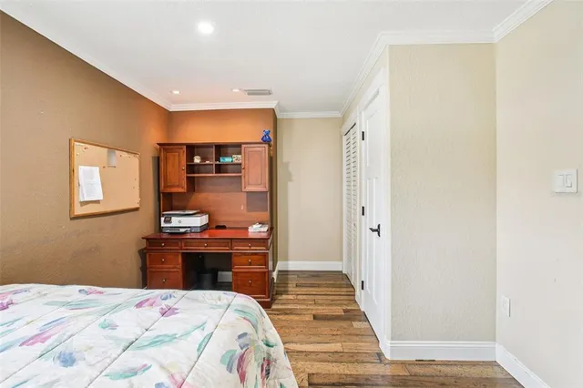 a bathroom with a granite countertop double vanity sink and mirror