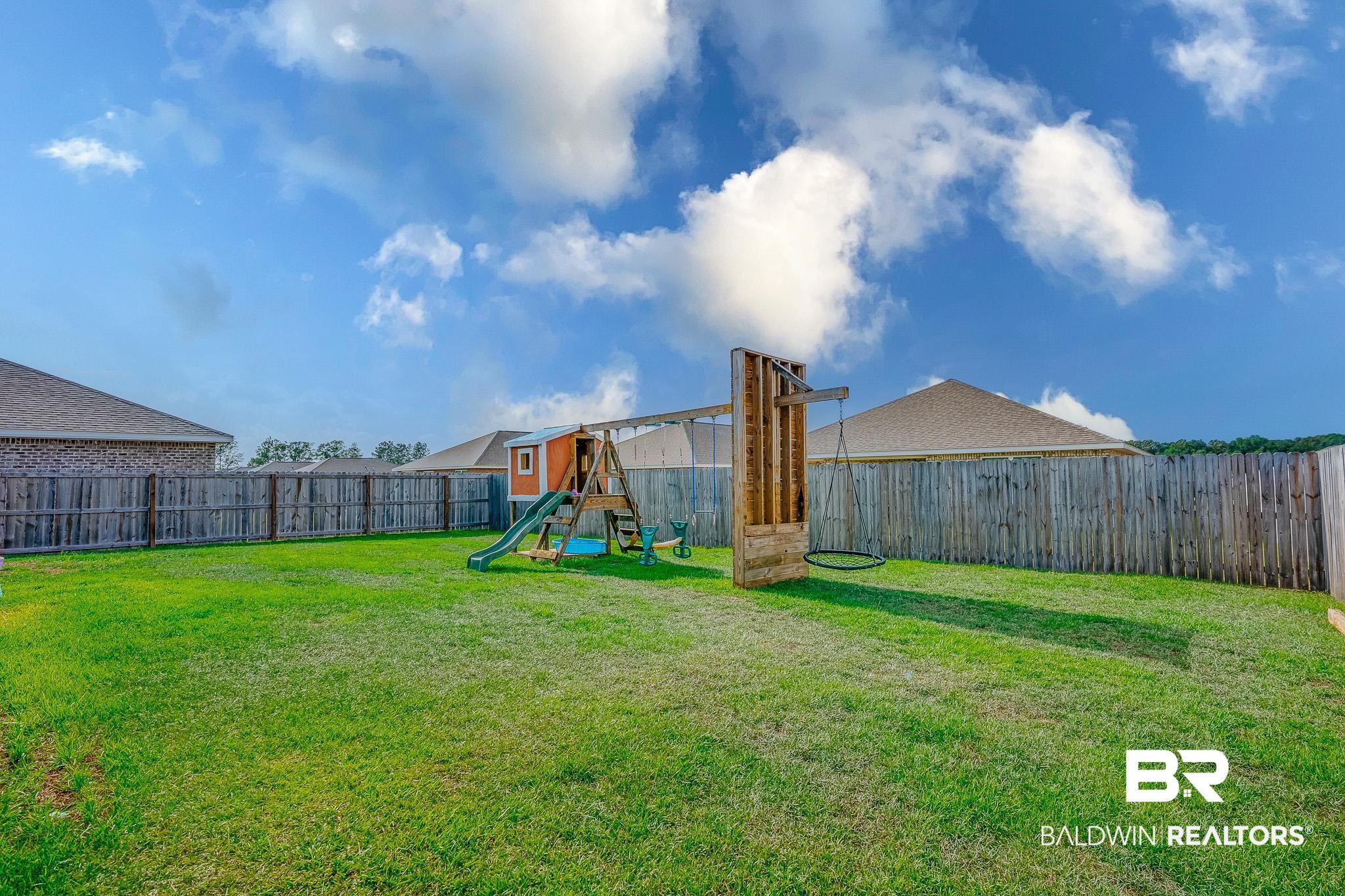 8242 Sycamore Way Semmes, AL 36575 - Photo 34 of 43 Fenced backyard featuring a playground
