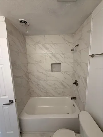 a bathroom with a tub and a shower