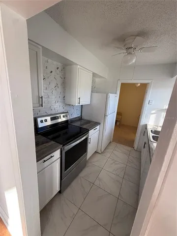 a kitchen with stainless steel appliances a stove and a refrigerator